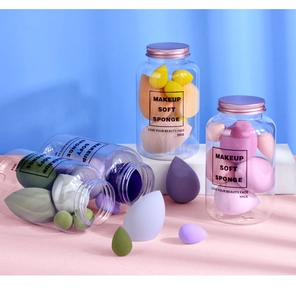 Set of 7 colorful makeup sponges in different shapes inside a transparent storage jar