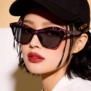 Retro cat-eye sunglasses with purple tortoiseshell frames and dark UV protection lenses
