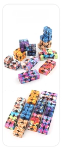 Macro display of assorted infinite cubes with galaxy and camouflage patterns for stress relief