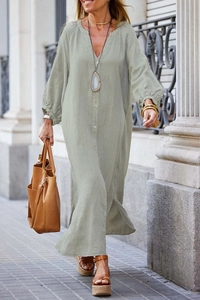 Detail of sage green cotton linen button-down dress with side slits and elastic cuffs