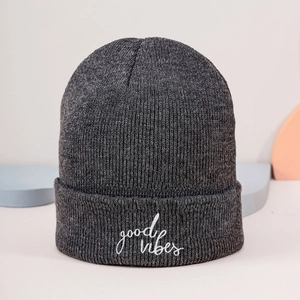 Detail of Good Vibes white embroidery on heather grey knitted beanie for autumn