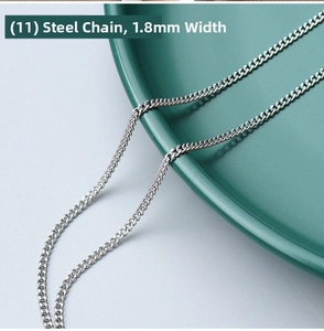 Macro shot of 1.8mm stainless steel curb chain with detailed links on a green plate