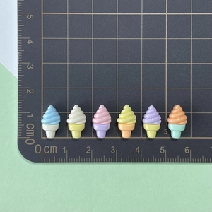Detailed view of colorful mini resin ice cream charms with cm scale for size reference
