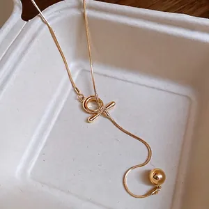 Minimalist gold-plated snake chain necklace with OT buckle and round ball pendant