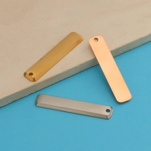 Detailed view of rectangular steel bar pendants in gold, silver, and rose gold finishes