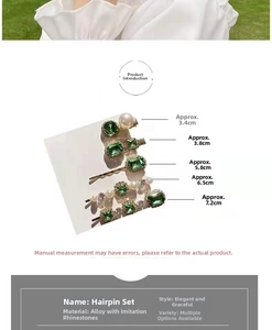 Detailed view of emerald rhinestone and pearl hair clips set with size measurements