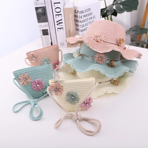 Detail of girls' woven straw hat and matching purse set with 3D floral accents