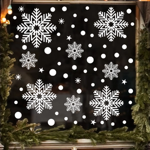 Detailed white snowflake static window stickers on glass with festive holiday lighting