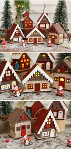 Macro shot of illuminated wooden Christmas house ornaments with warm LED lighting detail