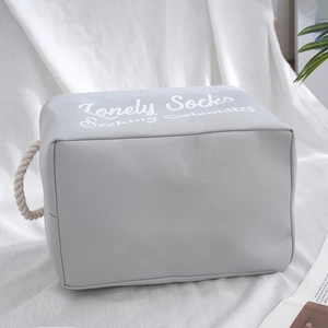 Grey fabric storage basket with rope handles and Lonely Socks quote for laundry and toys