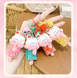 Macro shot of colorful rabbit ice cream keychains with flowing liquid and beads inside