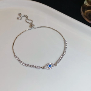 Detailed macro view of silver evil eye bracelet with blue zircon and adjustable chain