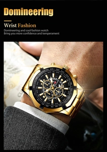 Detail of gold men's chronograph watch featuring tachymeter scale and luminous metal dial