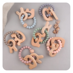 Detail of elephant-shaped beech wood and colorful silicone bead baby teething rings