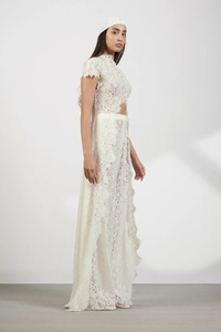 Close-up of white lace cardigan with delicate floral cutout textures and soft drape