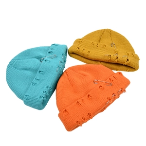 Distressed knit beanie hats with metal pins and rings in blue, orange and yellow colors