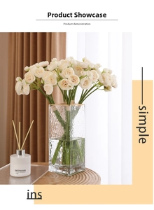 Close-up of cream artificial camellia flowers in a hammered glass vase with diffuser