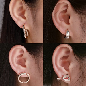 Collage of alloy earrings featuring twisted hoops, geometric studs, and heart designs