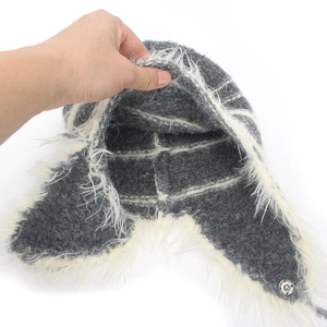 Winter knit trapper hat with gray exterior and soft white plush lining for cold protection