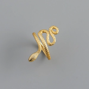 Macro shot of gold snake ring detail featuring textured scales and coiled wrap design