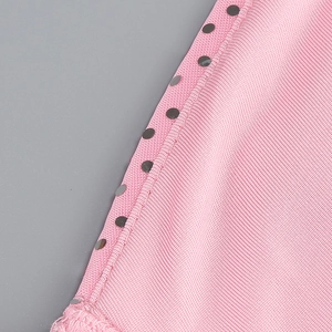Detail of pink knitted fabric with shimmering silver sequins and fine texture