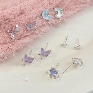 Iridescent butterfly and moon stud earrings set in silver finish with celestial charms