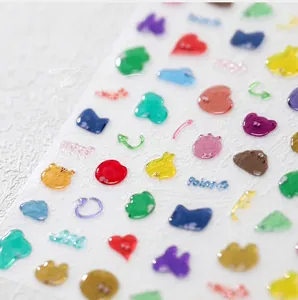 Macro shot of 3D jelly nail stickers with bear, heart, and cloud embossed designs