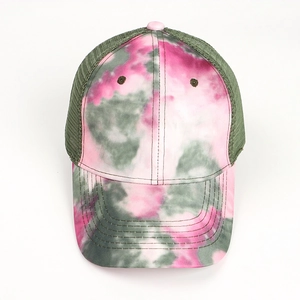 Top down view of a tie-dye trucker hat with pink and green mesh back and curved brim
