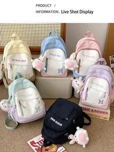 Multi-color school backpacks for girls featuring plush rabbit charms and nylon material
