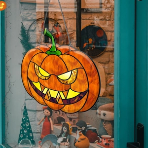 Close-up of Halloween pumpkin hanging decor with orange stained glass acrylic pattern