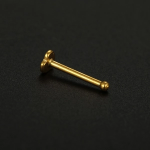 Detailed view of a 20G golden heart stainless steel nose stud with flat base