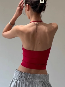 Rear view of red halter neck backless crop top highlighting fit and knit texture