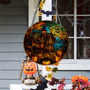 Detail of Halloween pumpkin and haunted house acrylic hanger on a porch with cobwebs