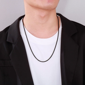 Minimalist black stainless steel chain necklace for men shown on a male model outfit