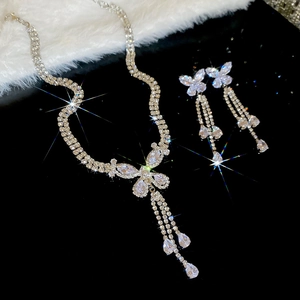 Sparkling silver butterfly necklace and earrings set with zircons on soft velvet