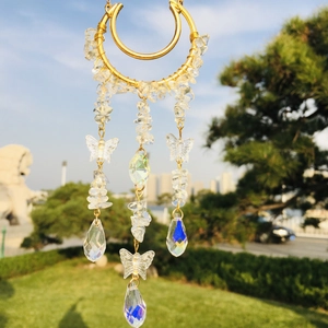 Macro shot of sun catcher detail with moon frame, crystal chips and rainbow prisms