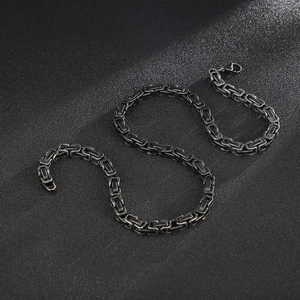 Close-up of square woven gunmetal stainless steel chain with secure lobster clasp