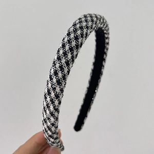 Macro shot of black and white houndstooth padded headband in woven wool fabric