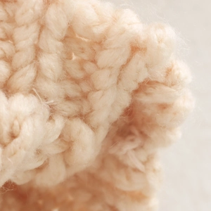 Oversized beige chunky knit cardigan sweater featuring a warm minimalist textured design