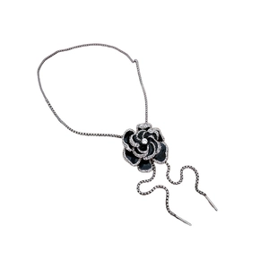 Long silver chain necklace featuring a black flower pendant with sparkling crystals