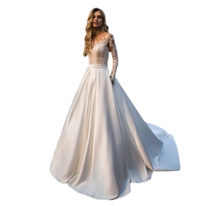 Elegant white wedding dress with lace long sleeves and satin A-line skirt on white background