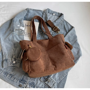 Detail of brown corduroy tote bag with small round coin purse and adjustable strap