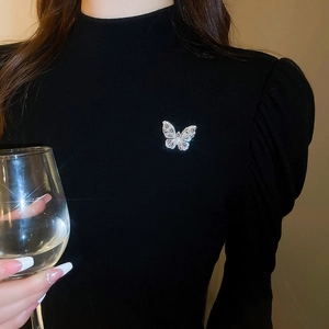 Sparkling butterfly brooch with teardrop zircon on a black dress lapel detail