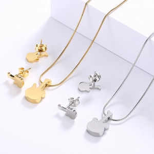 Polished guitar necklace and earrings jewelry set in gold and silver finish on white stand