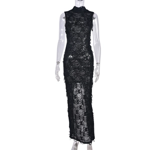 Detailed close-up of distressed knitted texture and hollow-out mesh on black dress