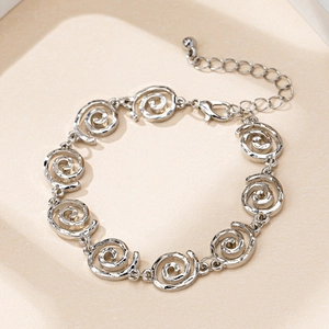 Elegant silver metal bracelet with hollow spiral pattern displayed in a gift box