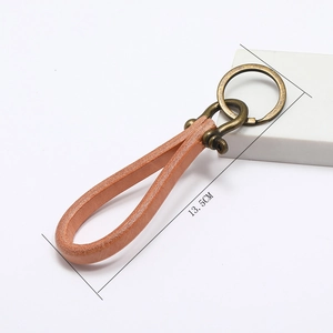Detail view of handmade brown leather keychain with vintage bronze horseshoe buckle and 13.5cm size
