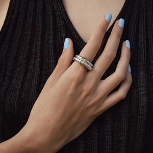 Detail of mixed-metal interlocking rings with silver bands and gold link accents