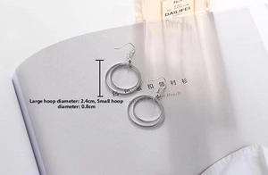 Detail of silver double circle hoop earrings with 2.4cm and 0.8cm nested rings