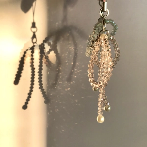 Handmade beaded phone strap with faceted crystal bow design and artistic shadow effect
